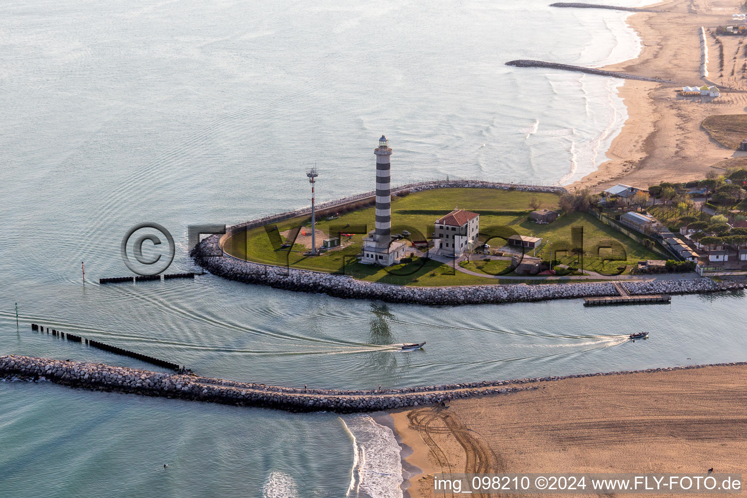 Aerial view of Light House Faro di Piave Vecchiaas a historic seafaring character in the coastal area of Adria in Lido di Jesolo in Venetien, Italy