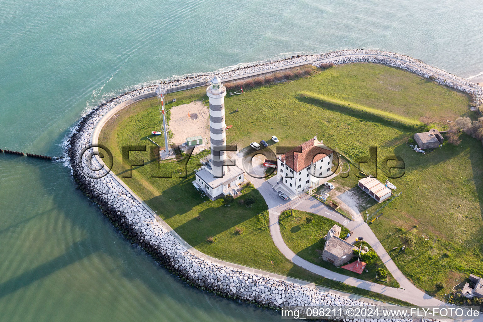 Aerial photograpy of Light House Faro di Piave Vecchiaas a historic seafaring character in the coastal area of Adria in Lido di Jesolo in Venetien, Italy