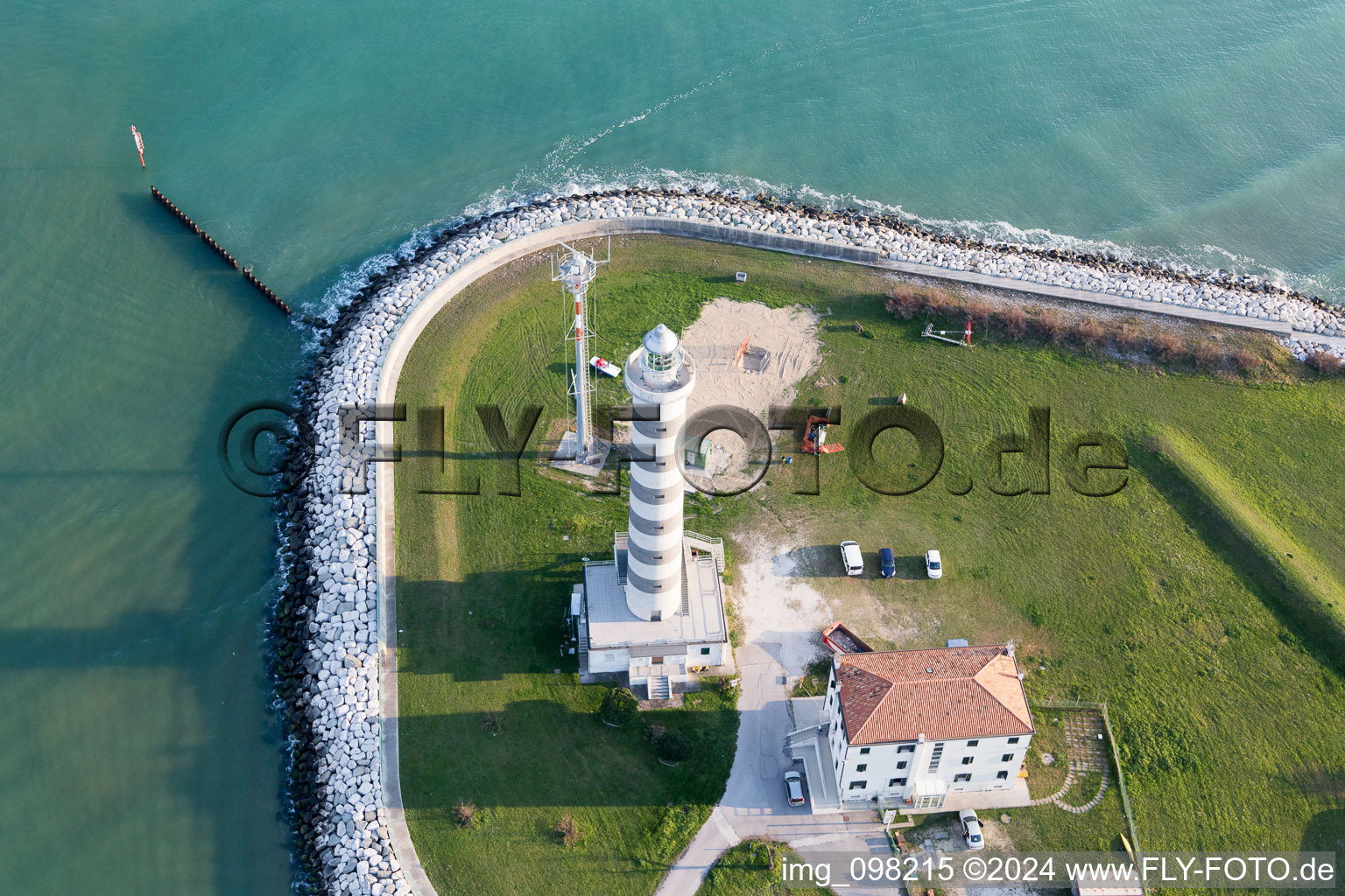 Oblique view of Light House Faro di Piave Vecchiaas a historic seafaring character in the coastal area of Adria in Lido di Jesolo in Venetien, Italy