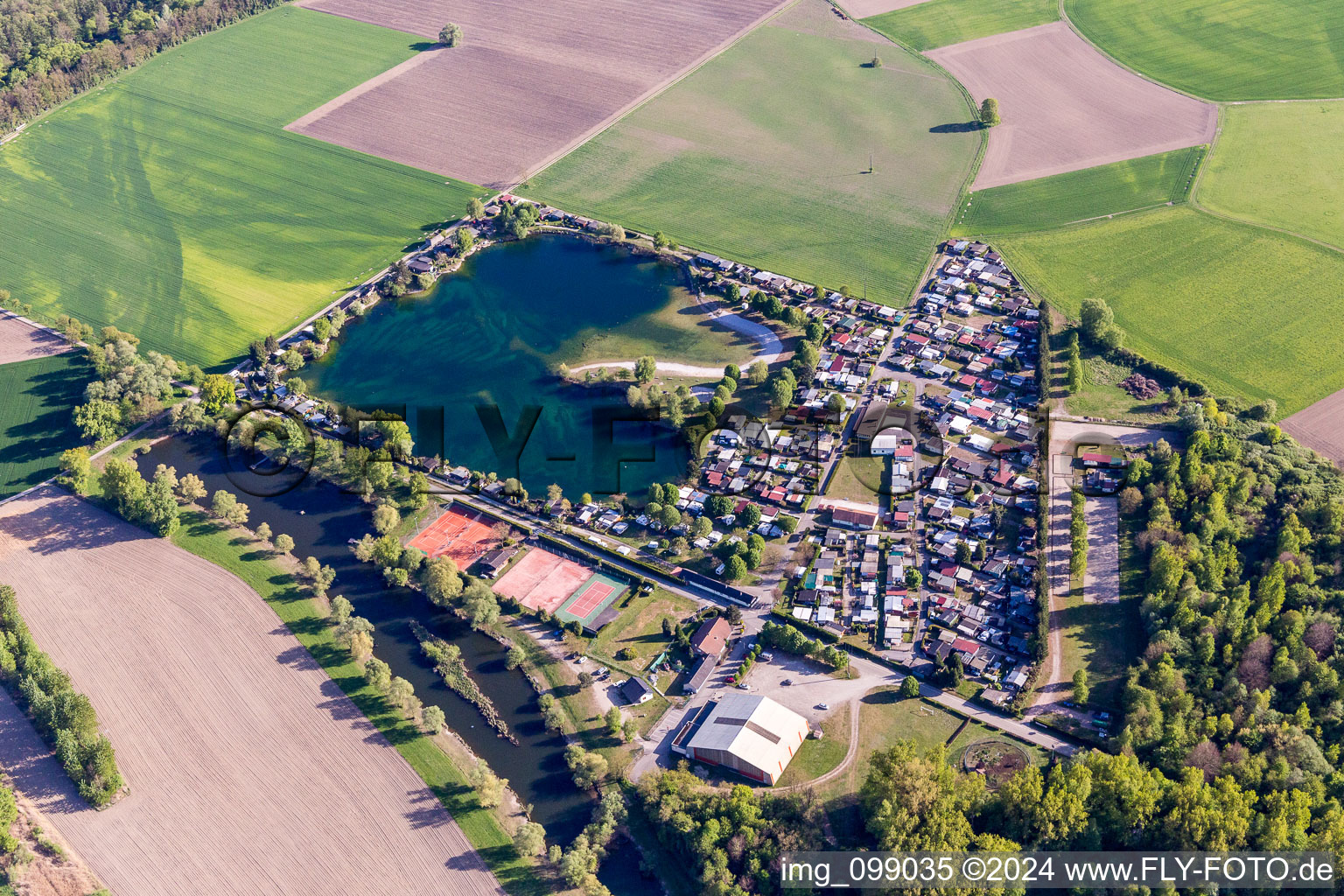 Camping with caravans and tents at a lake in Seltz in Grand Est, France