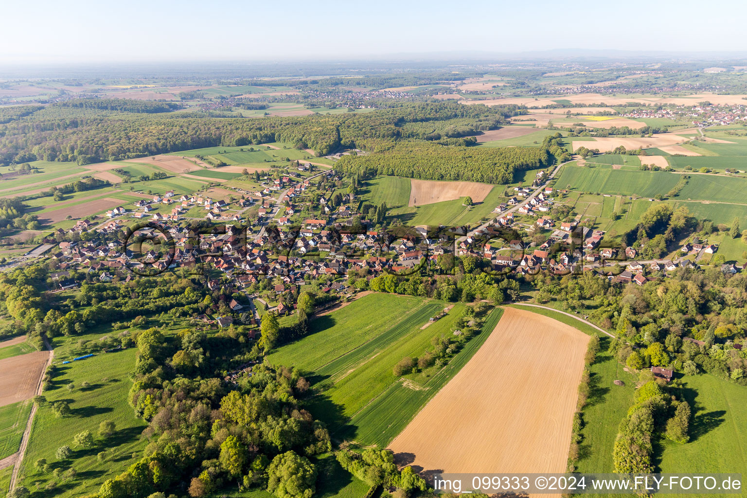 Village - view on the edge of agricultural fields and farmland in Lobsann in Grand Est, France