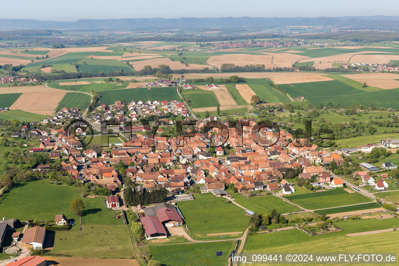Aerial view of Village - view on the edge of agricultural fields and farmland in Uhrwiller in Grand Est, France
