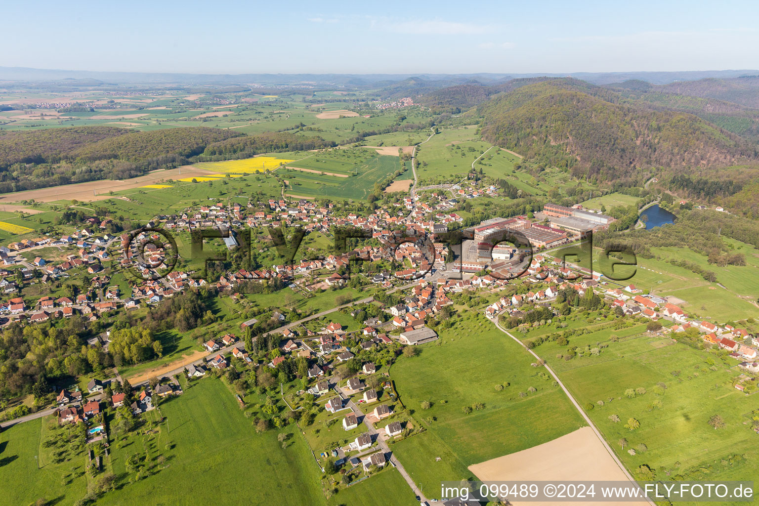 Aerial view of Village - view on the edge of agricultural fields and farmland in Zinswiller in Grand Est, France