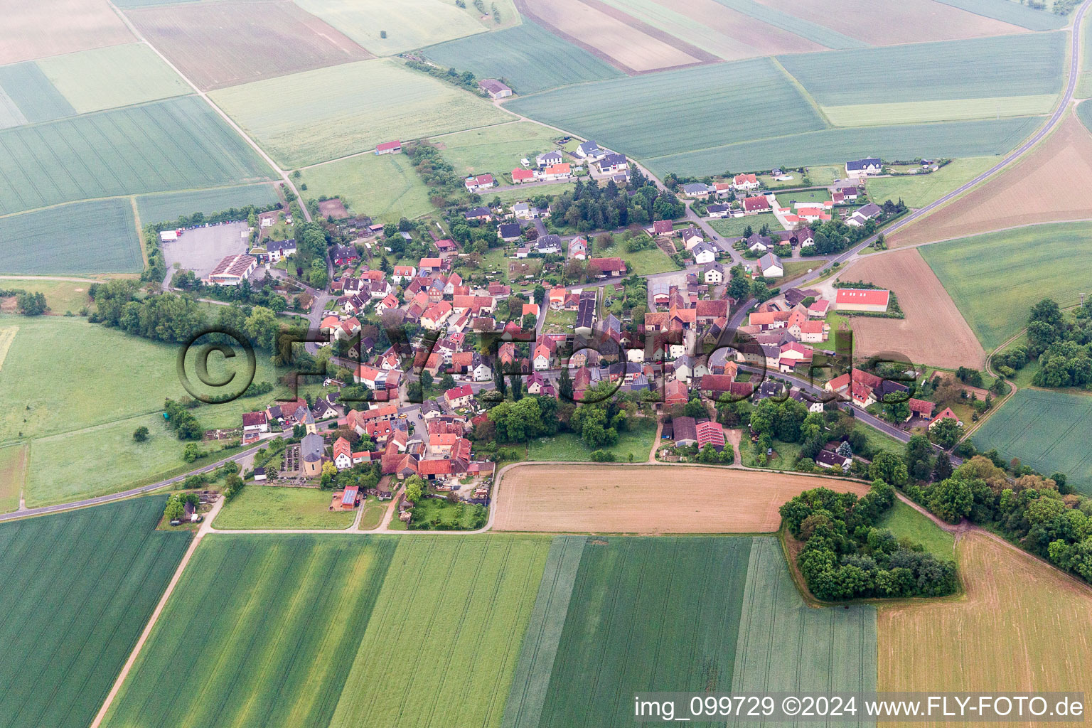 Village - view on the edge of agricultural fields and farmland in Bischwind in the state Bavaria, Germany