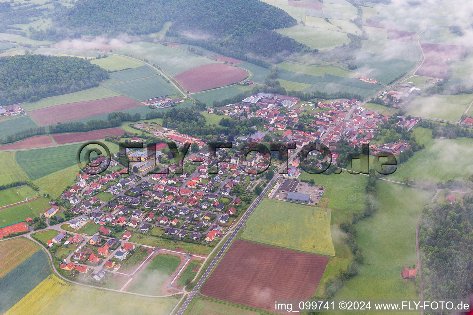 Village - view on the edge of agricultural fields and farmland in the district Untersteinbach in Rauhenebrach in the state Bavaria, Germany