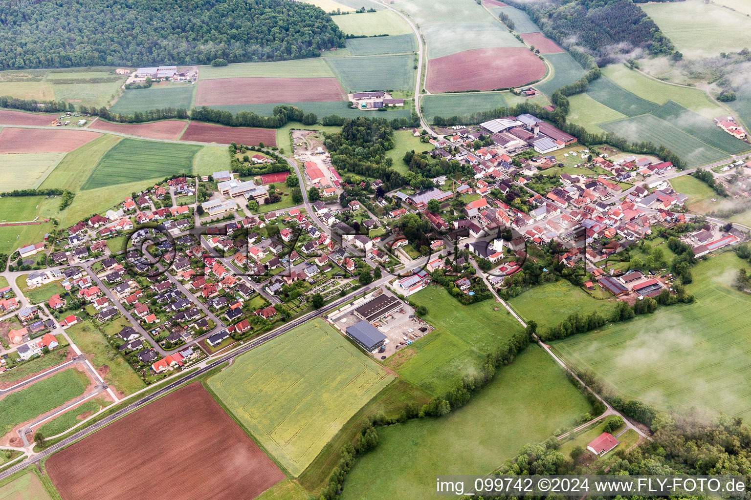 Village - view on the edge of agricultural fields and farmland in Untersteinbach in the state Bavaria, Germany