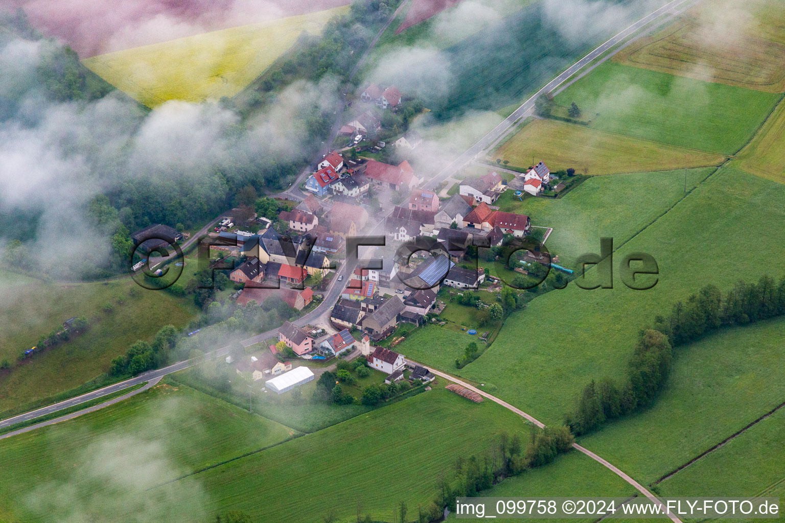 Aerial view of Place under clouds in the district Zettmannsdorf in Schönbrunn im Steigerwald in the state Bavaria, Germany