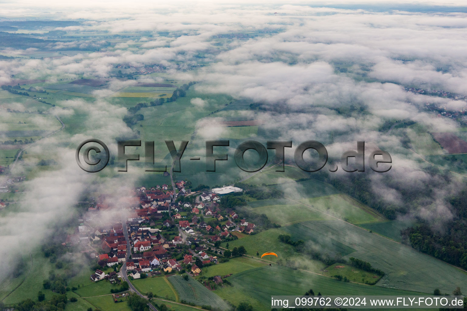 Village under clouds in the district Ampferbach in Burgebrach in the state Bavaria, Germany