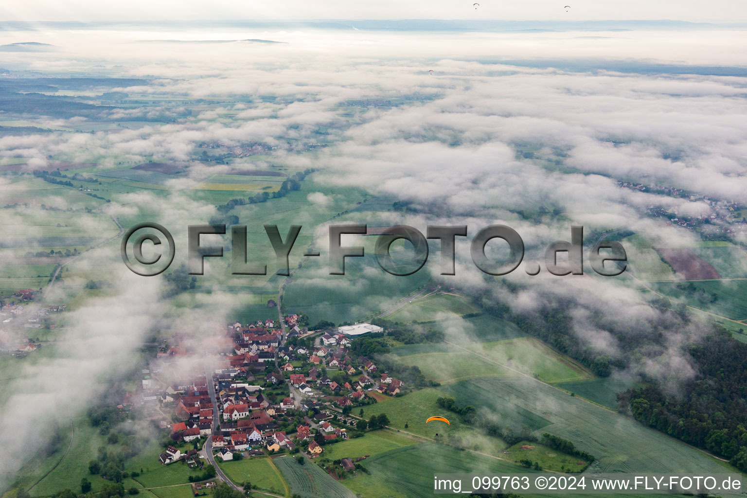 Aerial view of Village under clouds in the district Ampferbach in Burgebrach in the state Bavaria, Germany