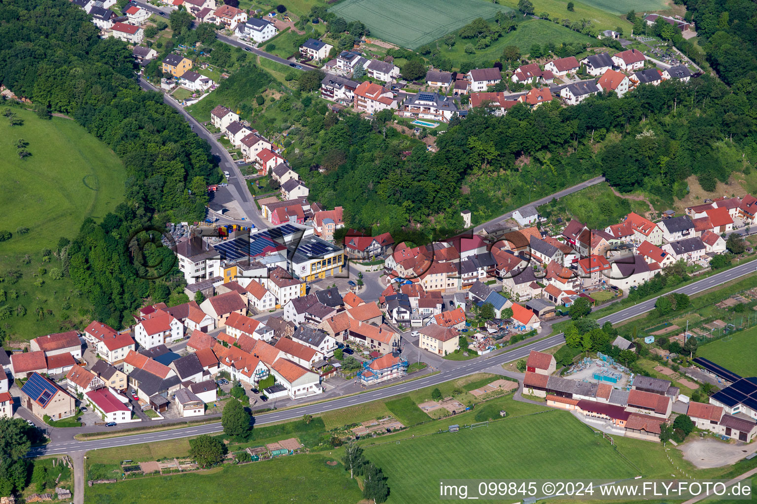 Oblique view of Village - view on the edge of agricultural fields and farmland in the district Rossstadt in Eltmann in the state Bavaria, Germany