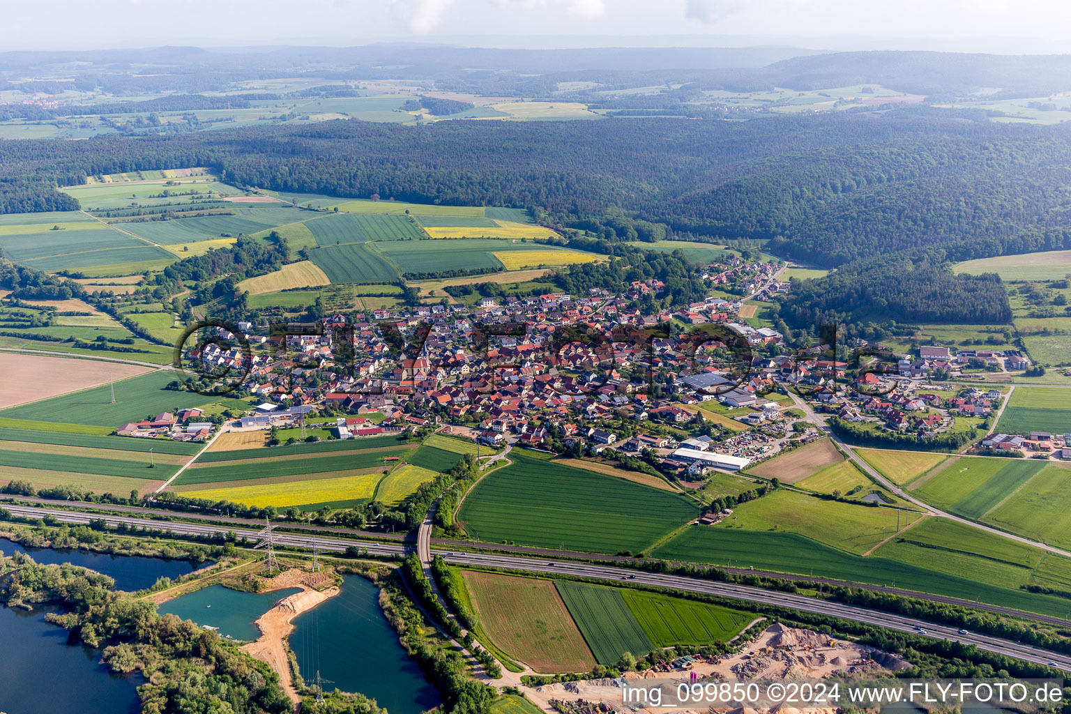 Village - view on the edge of agricultural fields and farmland in Stettfeld in the state Bavaria, Germany