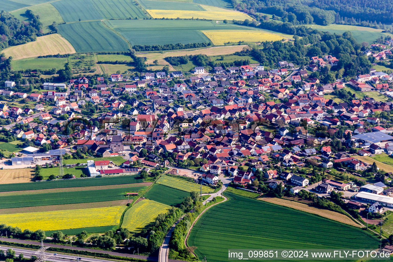 Aerial view of Village - view on the edge of agricultural fields and farmland in Stettfeld in the state Bavaria, Germany