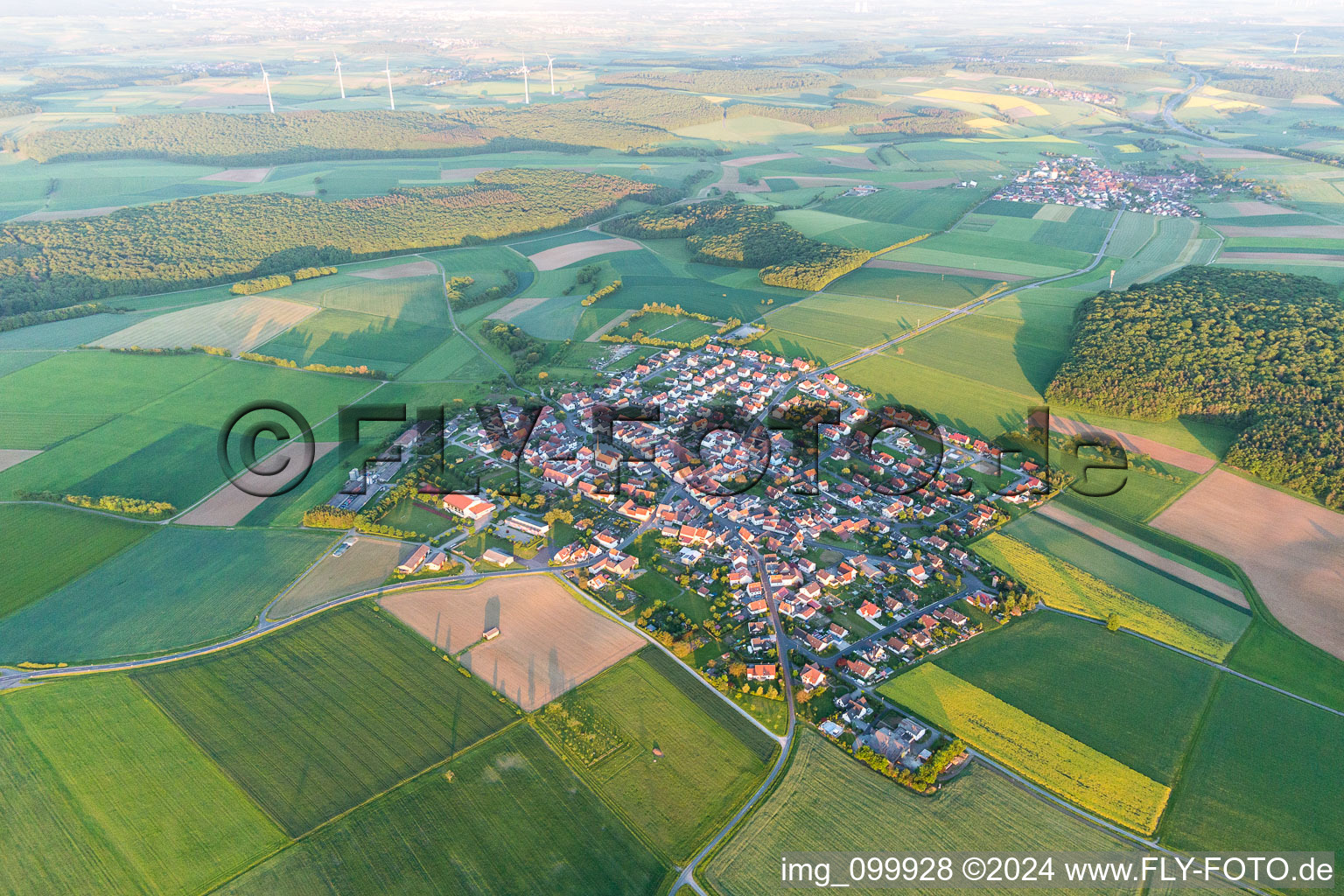 Village - view on the edge of agricultural fields and farmland in Wasserlosen in the state Bavaria, Germany