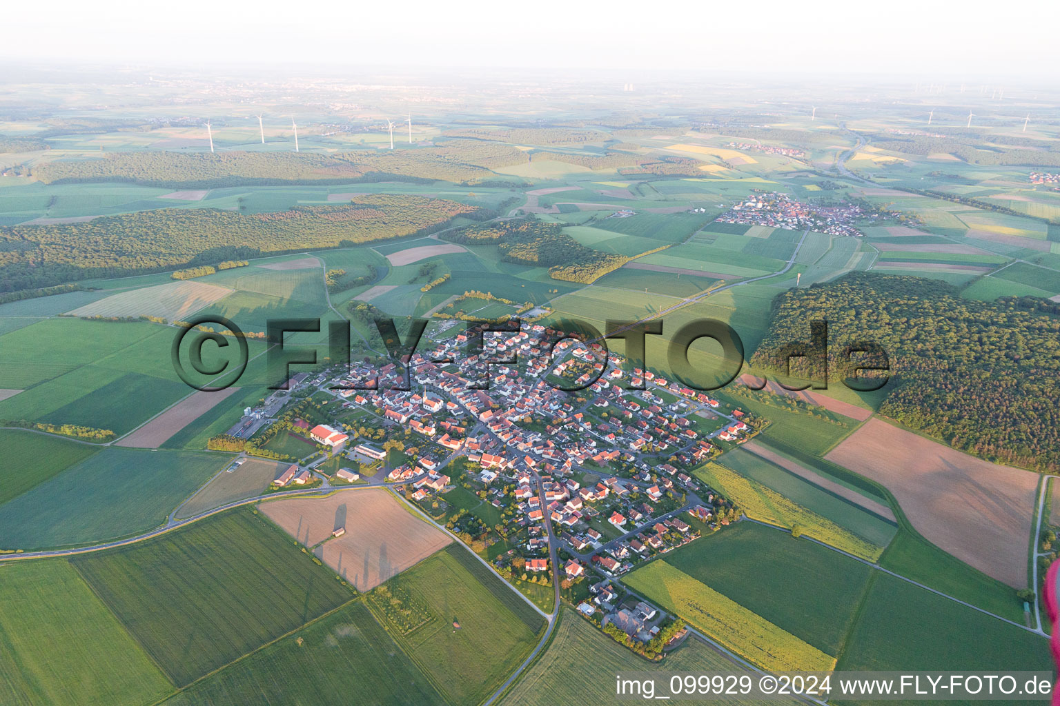 Aerial view of Village - view on the edge of agricultural fields and farmland in Wasserlosen in the state Bavaria, Germany