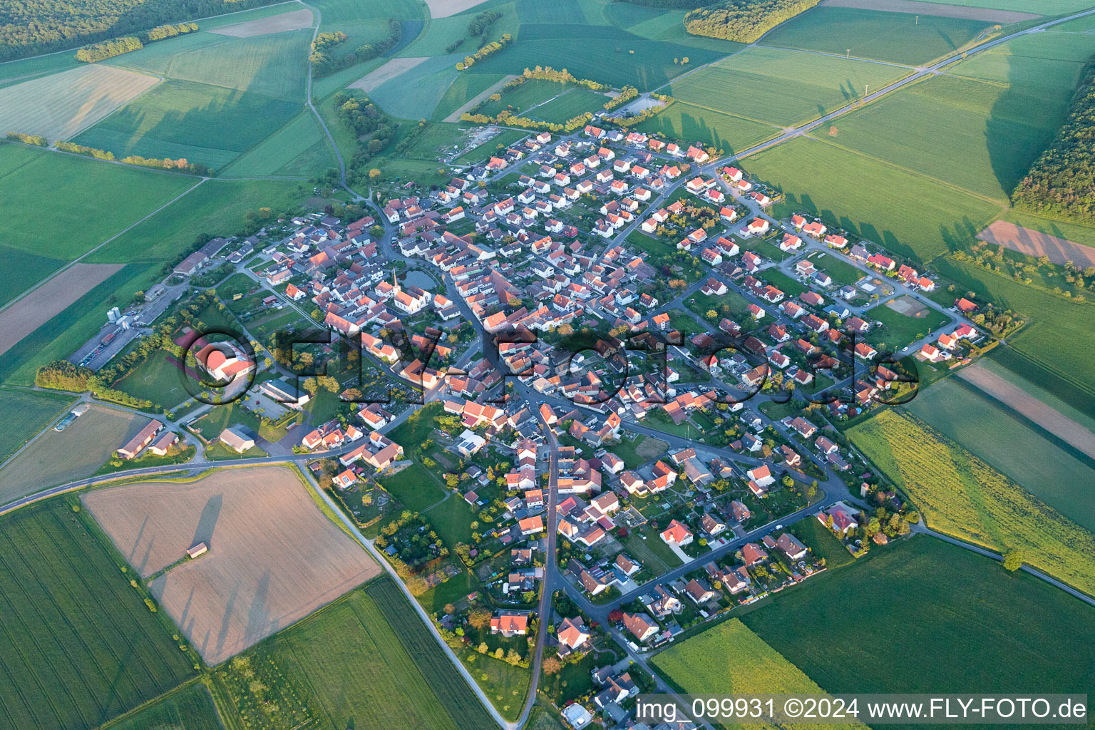 Oblique view of Village - view on the edge of agricultural fields and farmland in Wasserlosen in the state Bavaria, Germany