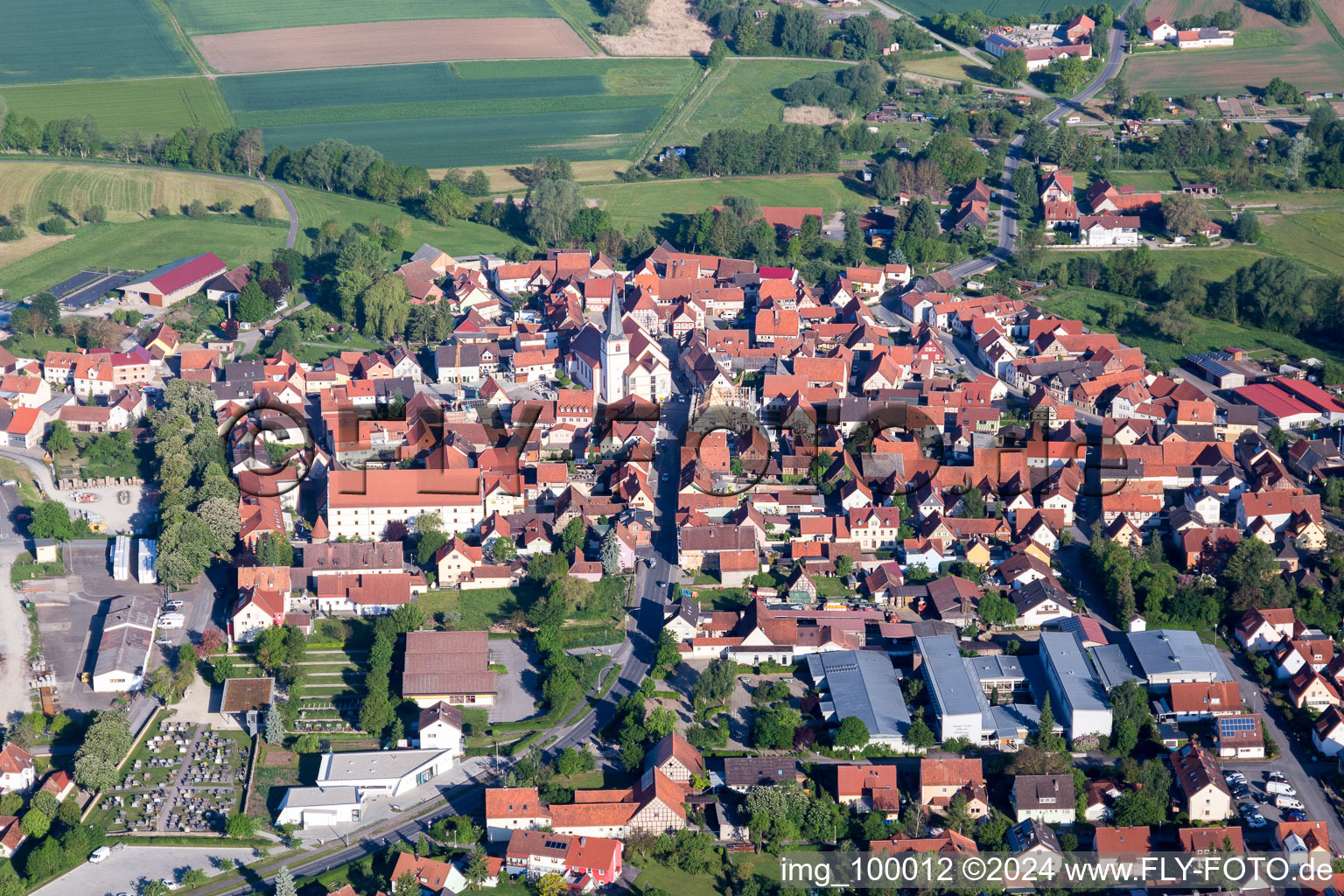 Aerial view of Village - view on the edge of agricultural fields and farmland in Stadtlauringen in the state Bavaria, Germany