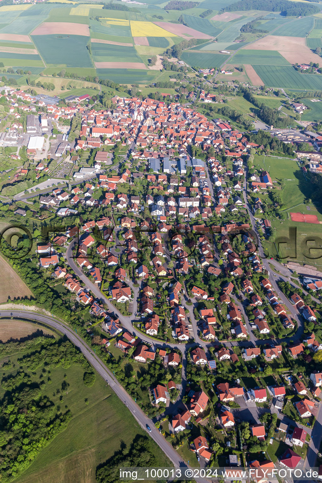 Aerial photograpy of Village - view on the edge of agricultural fields and farmland in Stadtlauringen in the state Bavaria, Germany