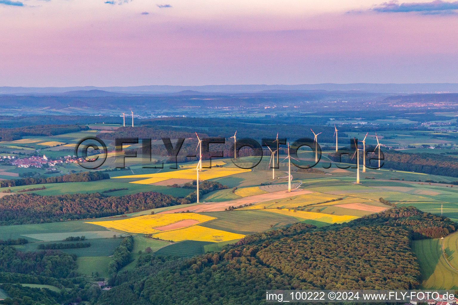 Wind farm in the evening light in the district Marktsteinach in Schonungen in the state Bavaria, Germany