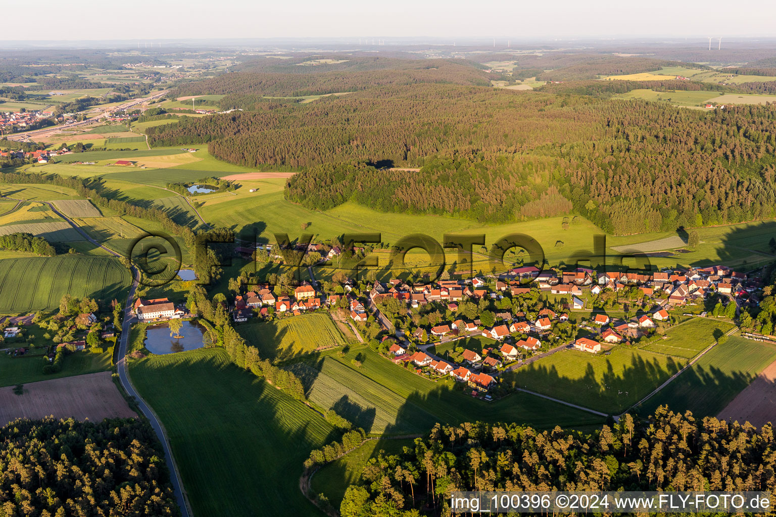 Village - view on the edge of agricultural fields and farmland in the district Rehweiler in Geiselwind in the state Bavaria, Germany