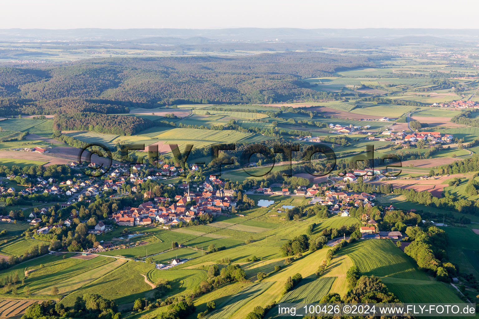 Village - view on the edge of agricultural fields and farmland in Untersteinach in the state Bavaria, Germany