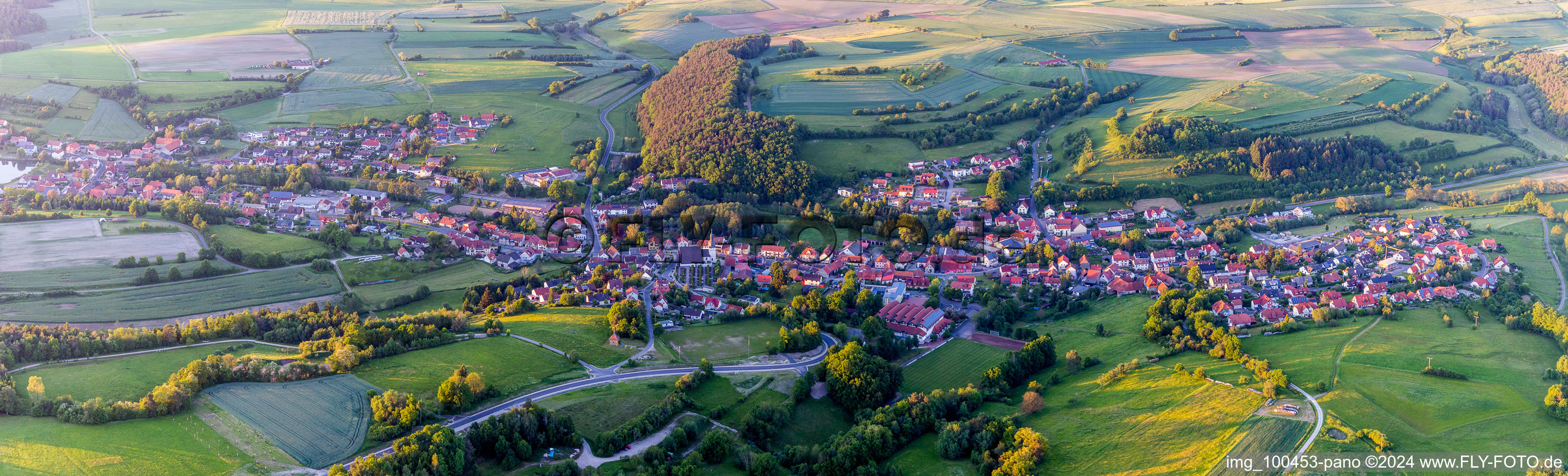 Village - view on the edge of agricultural fields and farmland in Trossenfurt in the state Bavaria, Germany