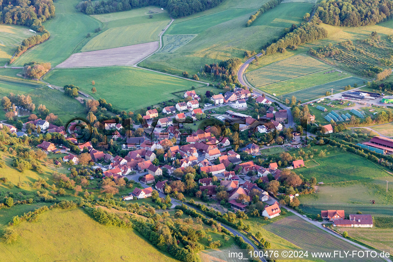 Village - view on the edge of agricultural fields and farmland in Eschenau in the state Bavaria, Germany