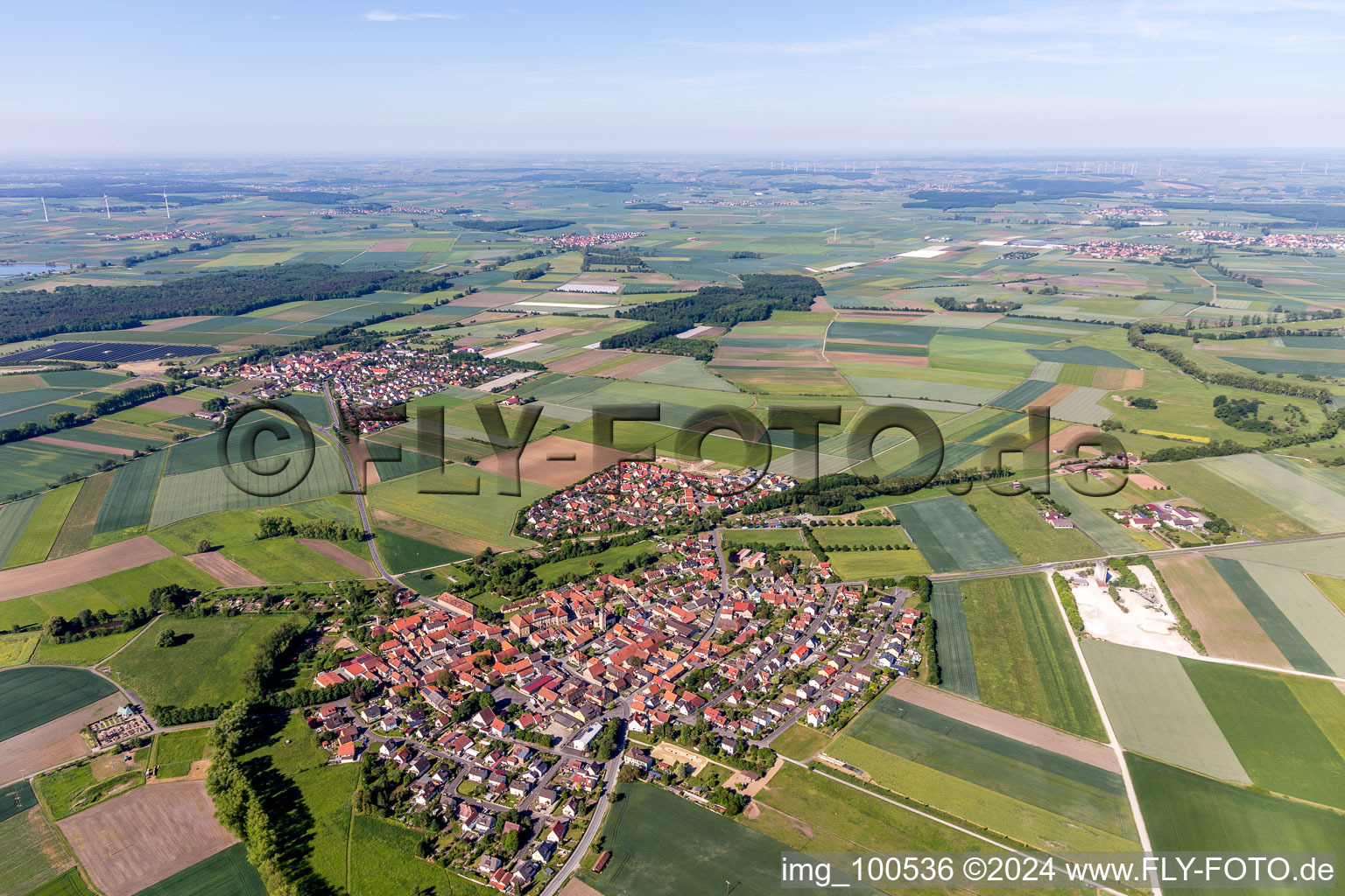 Aerial photograpy of Village - view on the edge of agricultural fields and farmland in Sulzheim in the state Bavaria, Germany