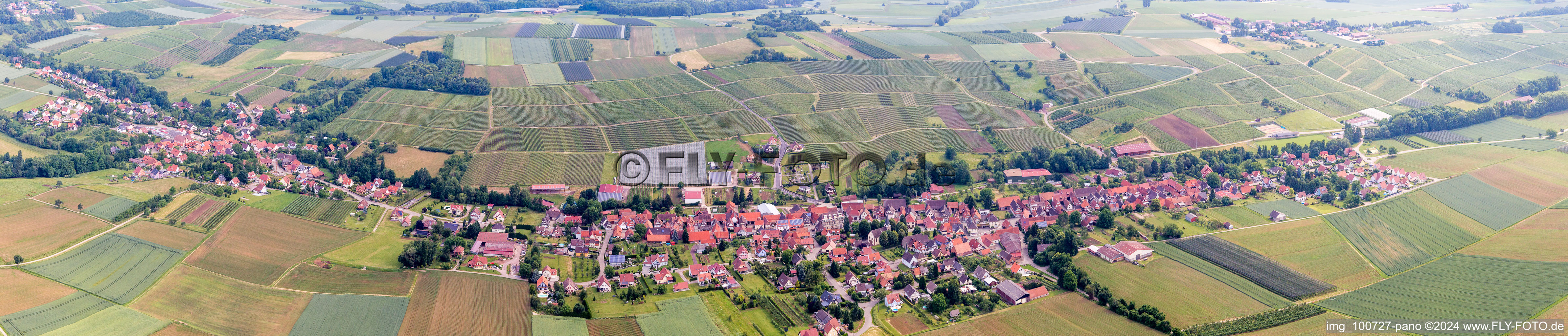 Aerial view of Panoramic perspective Village - view on the edge of agricultural fields and farmland in Steinseltz in Grand Est, France