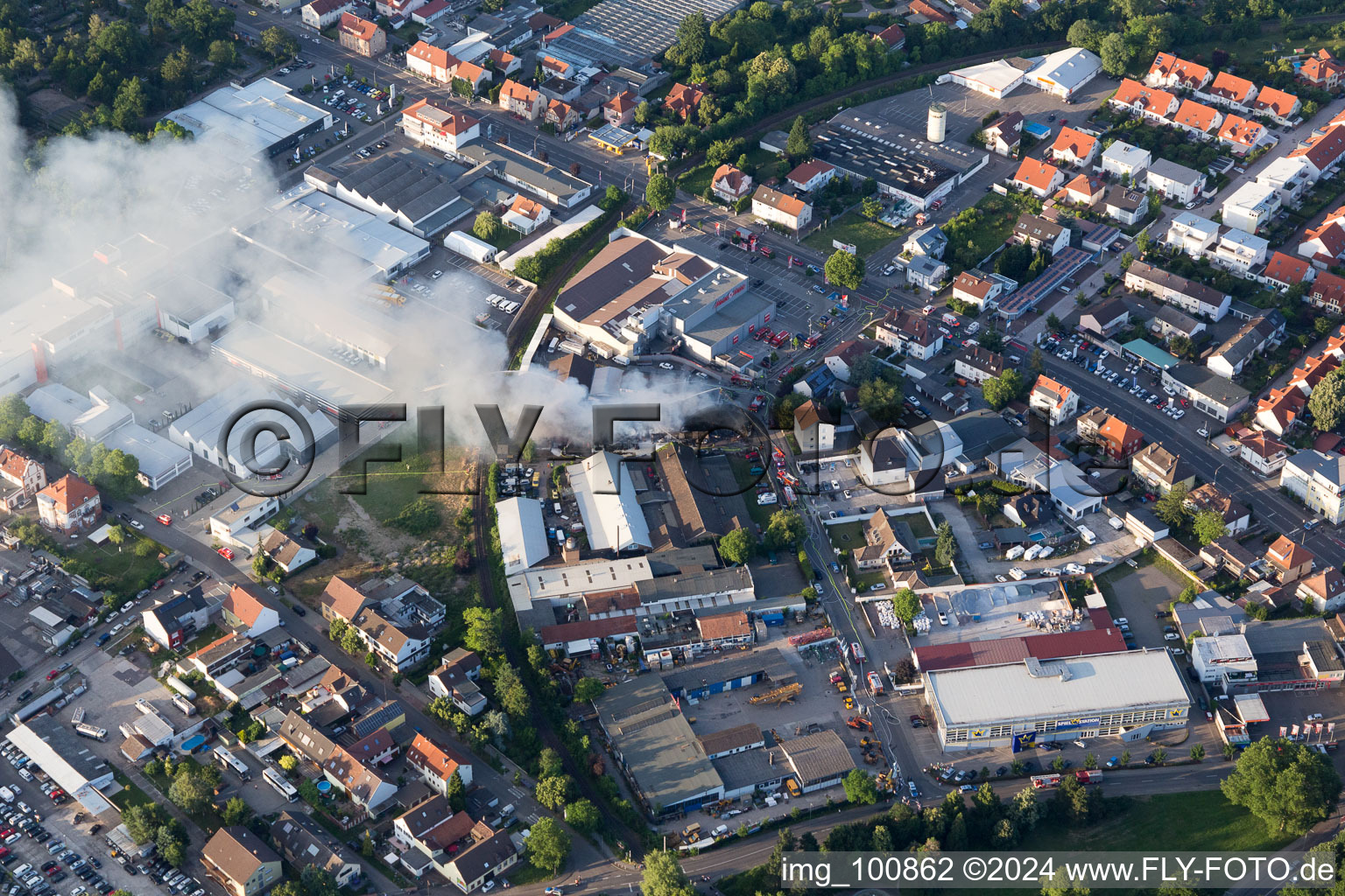 Aerial view of Smoke and flames during the fire fighting to fire of a storage all for antiqities in the Werkstrasse in Speyer in the state Rhineland-Palatinate, Germany