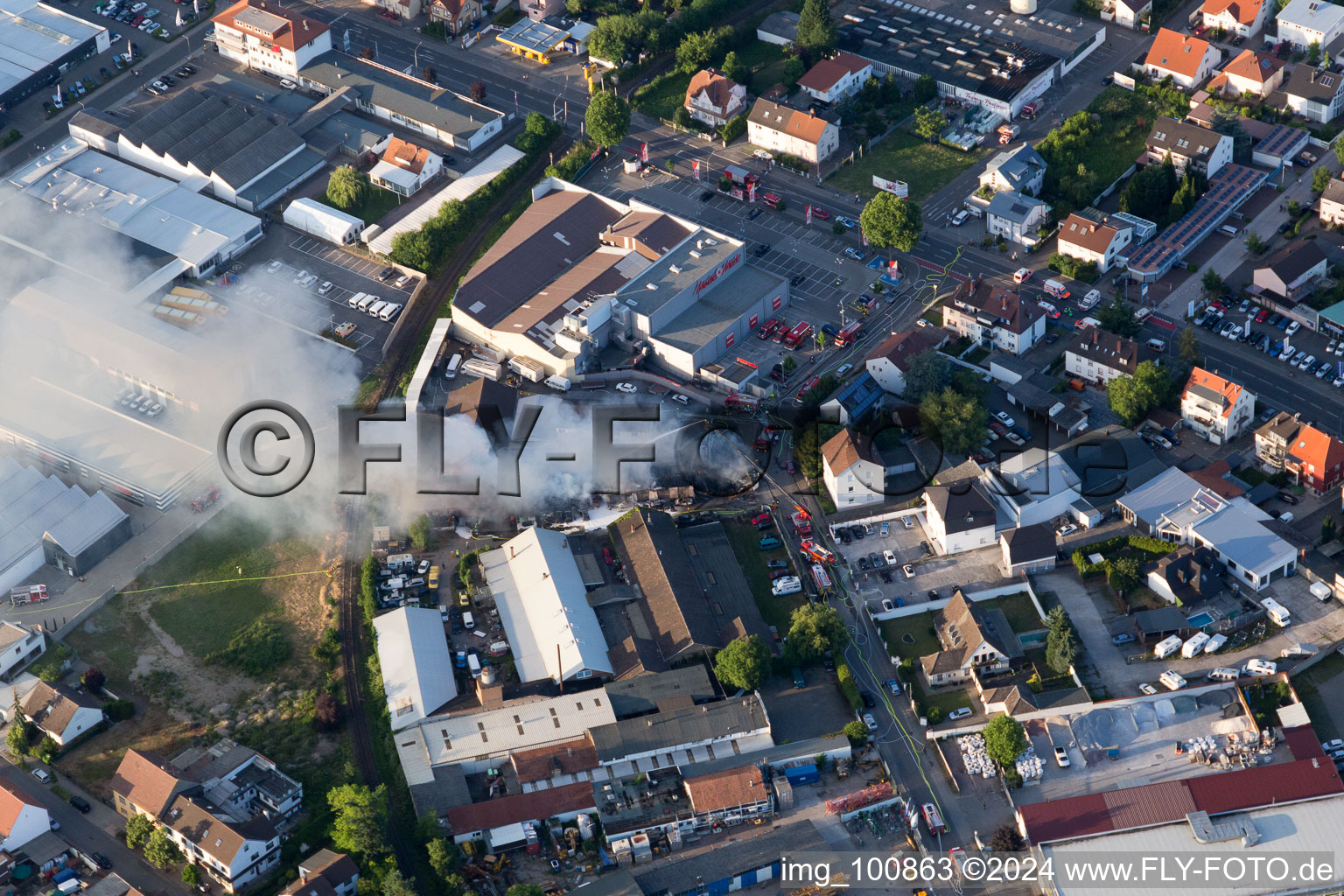 Aerial photograpy of Smoke and flames during the fire fighting to fire of a storage all for antiqities in the Werkstrasse in Speyer in the state Rhineland-Palatinate, Germany