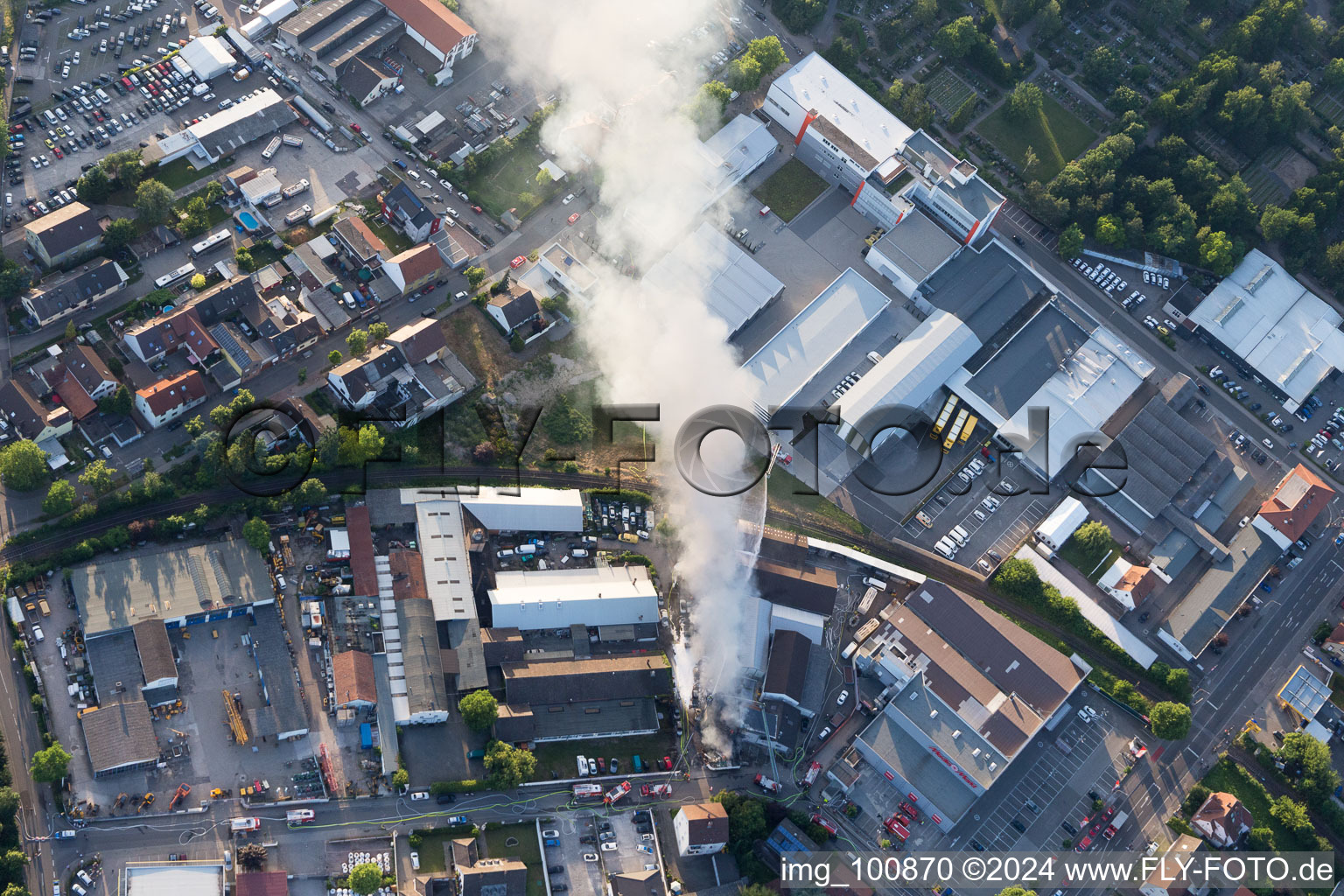 Smoke and flames during the fire fighting to fire of a storage all for antiqities in the Werkstrasse in Speyer in the state Rhineland-Palatinate, Germany seen from above