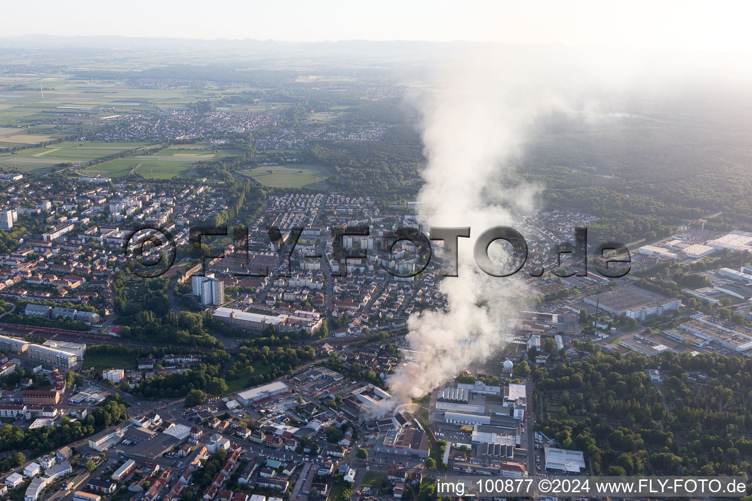 Smoke and flames during the fire fighting to fire of a storage all for antiqities in the Werkstrasse in Speyer in the state Rhineland-Palatinate, Germany viewn from the air