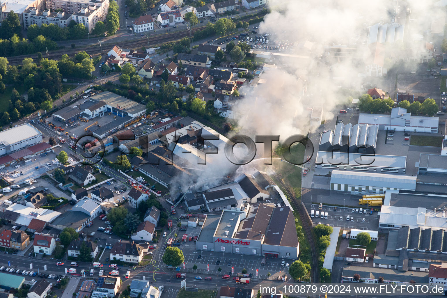 Drone recording of Smoke and flames during the fire fighting to fire of a storage all for antiqities in the Werkstrasse in Speyer in the state Rhineland-Palatinate, Germany