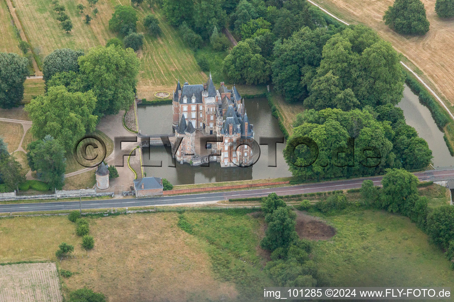 Building and castle park systems of water castle Chateau de Combreux in Combreux in Centre-Val de Loire, France seen from above