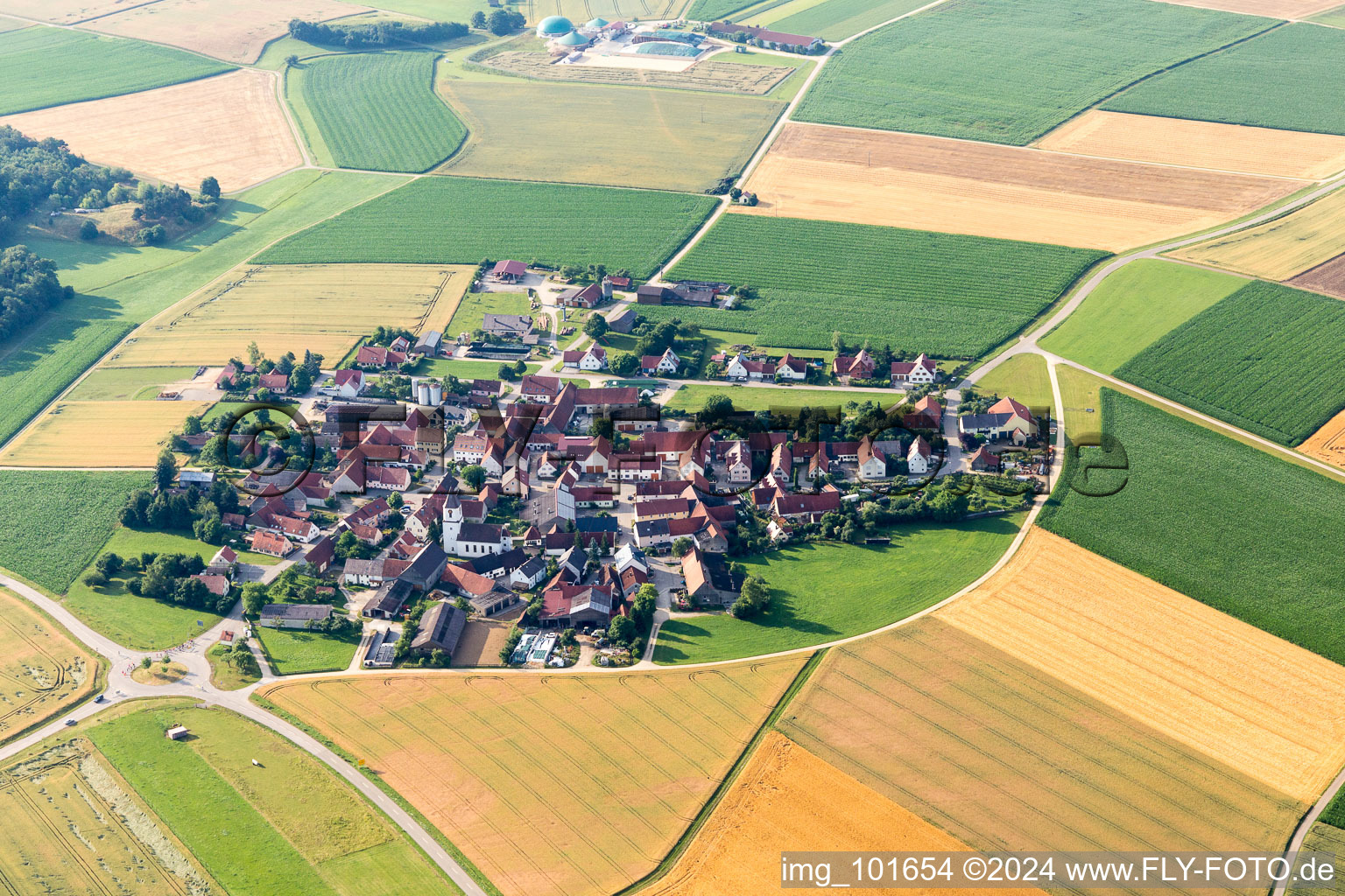 Aerial view of Village - view on the edge of agricultural fields and farmland in Moenchsdeggingen in the state Bavaria, Germany