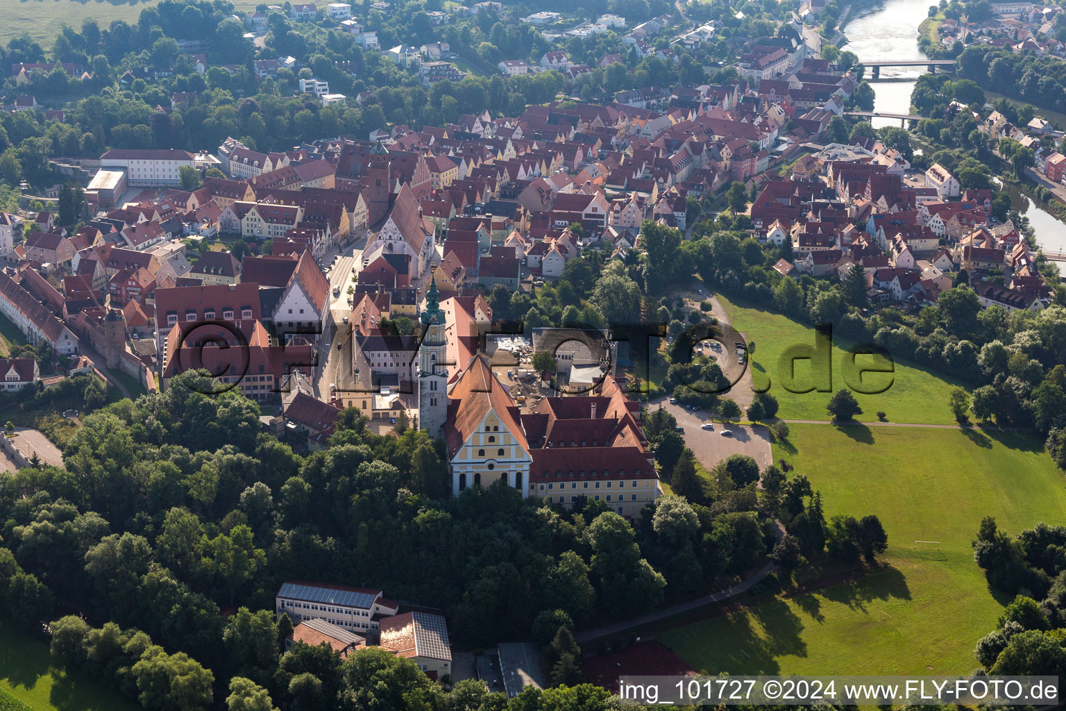 Aerial view of Complex of buildings of the monastery Heilig Kreuz in front of Ried island in Donauwoerth in the state Bavaria, Germany