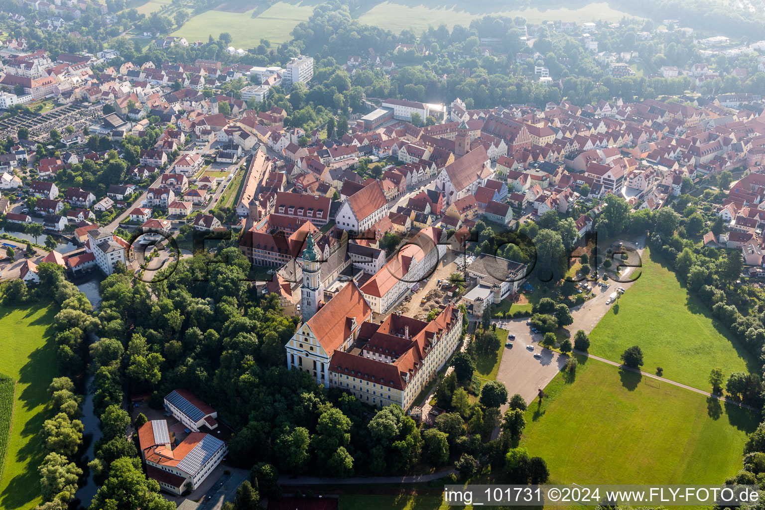 Oblique view of Complex of buildings of the monastery Heilig Kreuz in front of Ried island in Donauwoerth in the state Bavaria, Germany