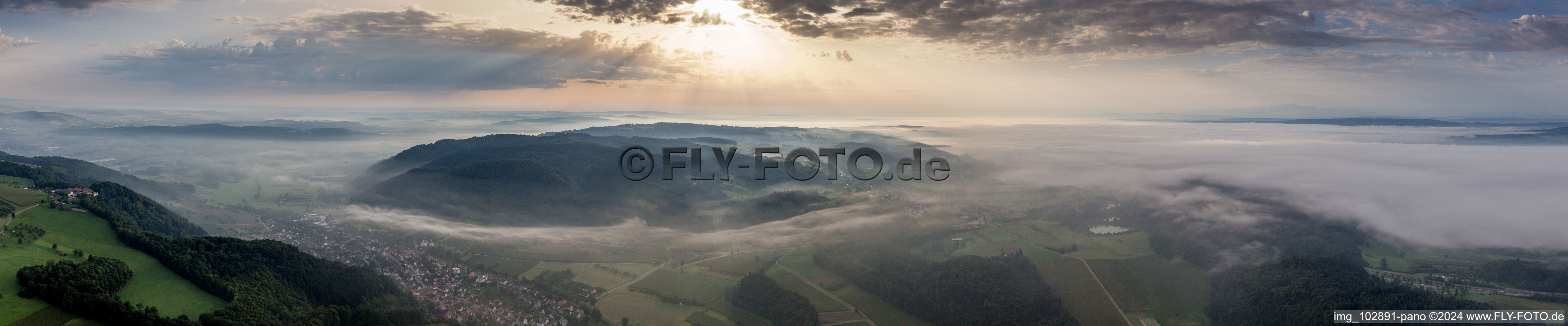 The Lake of Constance hidden by morning fog over Village - view on the edge of agricultural fields and farmland in the district Stahringen in Radolfzell am Bodensee in the state Baden-Wurttemberg, Germany