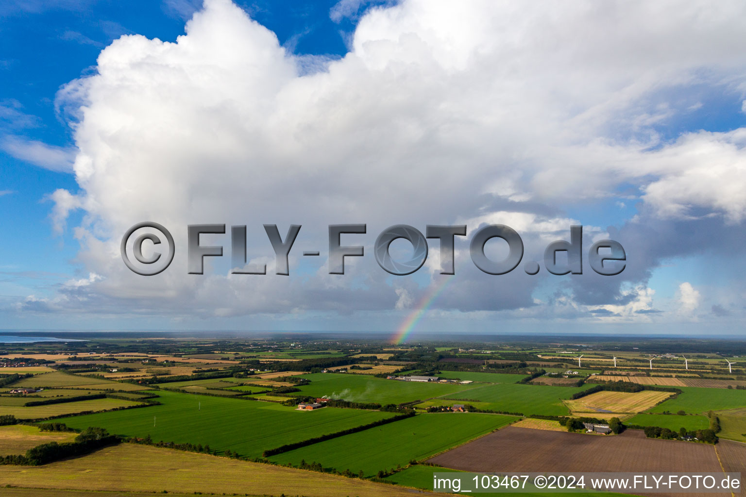 Rainbow under cumulus in Janderup in the state South Denmark, Denmark