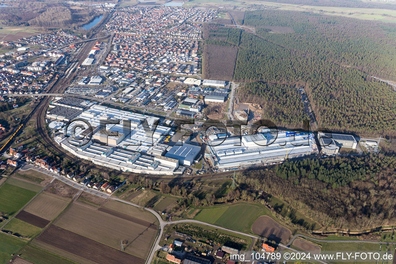 Oblique view of Extension - new building - construction site on the factory premises of SEW-EURODRIVE GmbH & Co KG in Graben-Neudorf in the state Baden-Wurttemberg, Germany