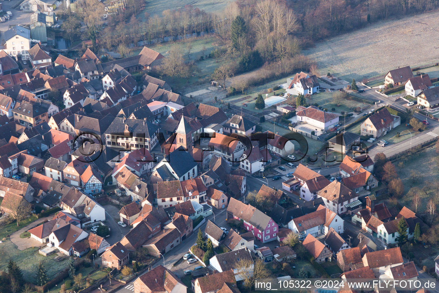 Aerial view of Protestantic Church building in the center of a circle of houses in the village of in Dossenheim-sur-Zinsel in Grand Est, France