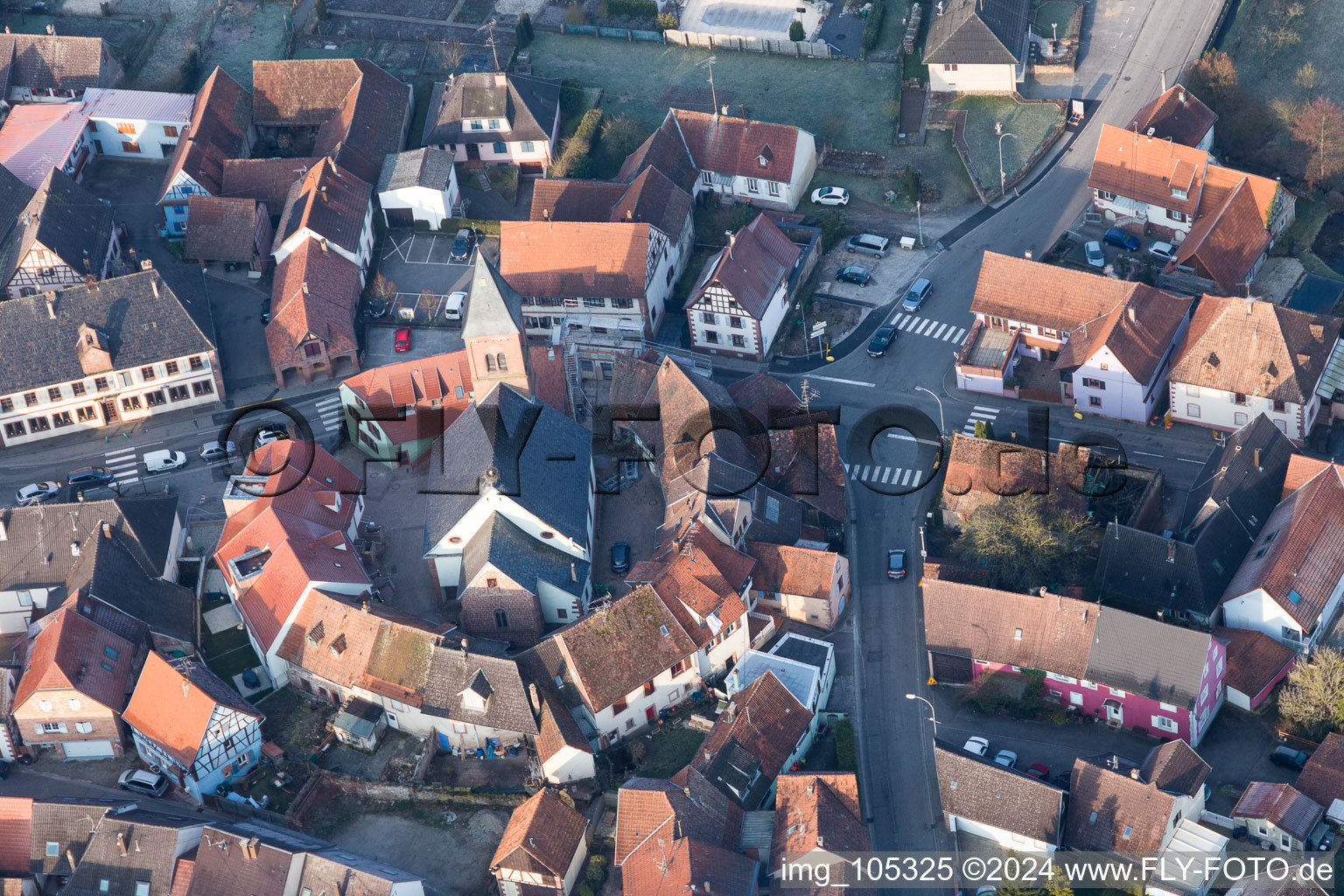 Oblique view of Protestantic Church building in the center of a circle of houses in the village of in Dossenheim-sur-Zinsel in Grand Est, France