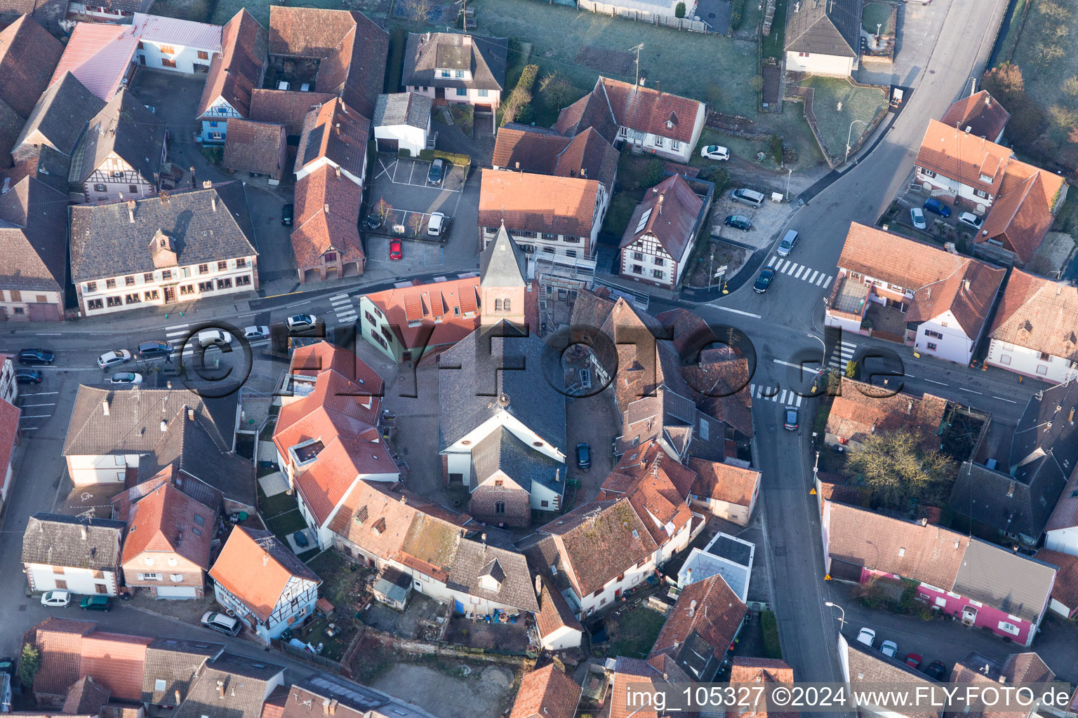 Protestantic Church building in the center of a circle of houses in the village of in Dossenheim-sur-Zinsel in Grand Est, France out of the air