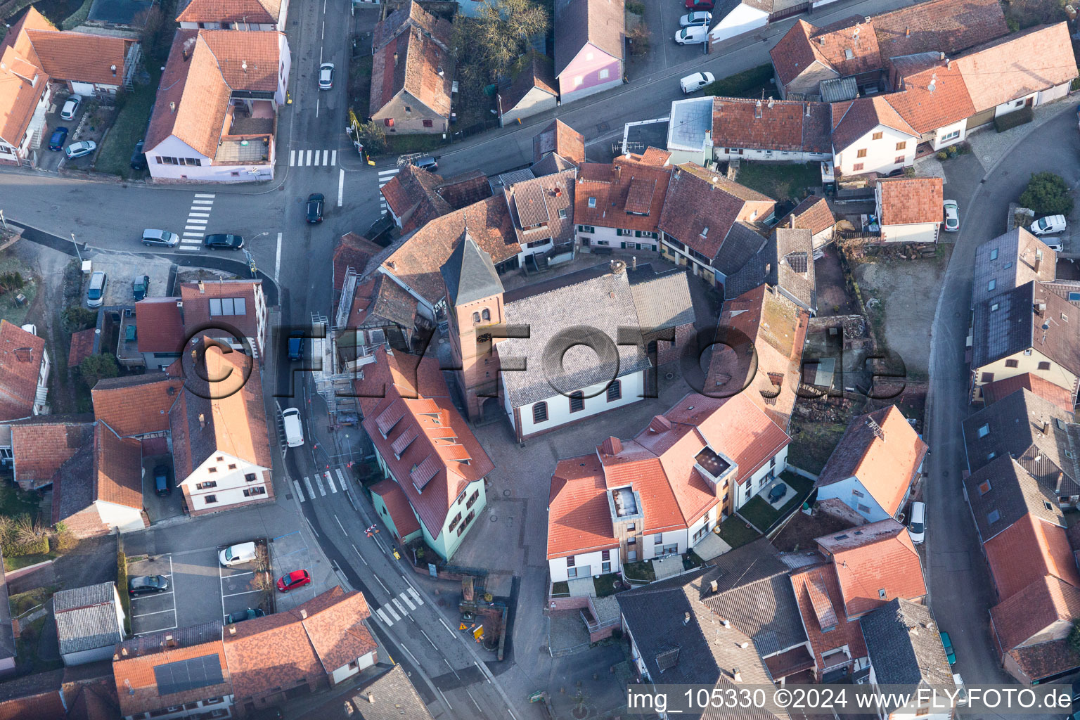 Bird's eye view of Protestantic Church building in the center of a circle of houses in the village of in Dossenheim-sur-Zinsel in Grand Est, France