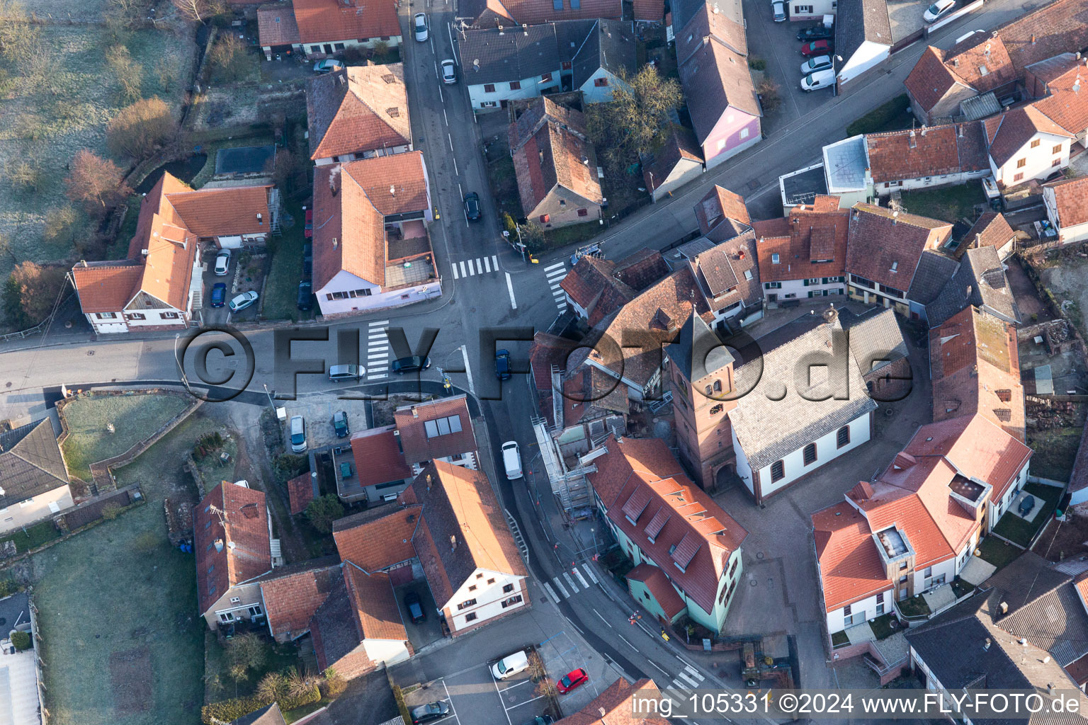 Protestantic Church building in the center of a circle of houses in the village of in Dossenheim-sur-Zinsel in Grand Est, France viewn from the air