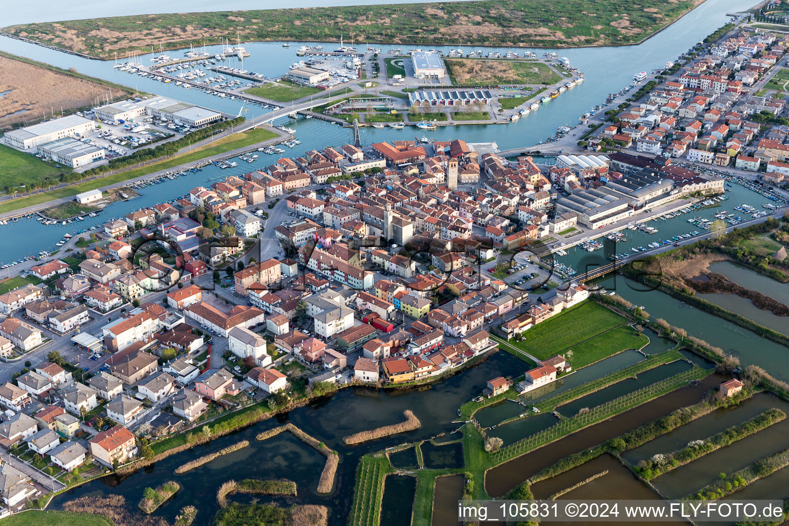 Aerial view of Water surface at the seaside mole of in Marano Lagunare in Friuli-Venezia Giulia, Italy