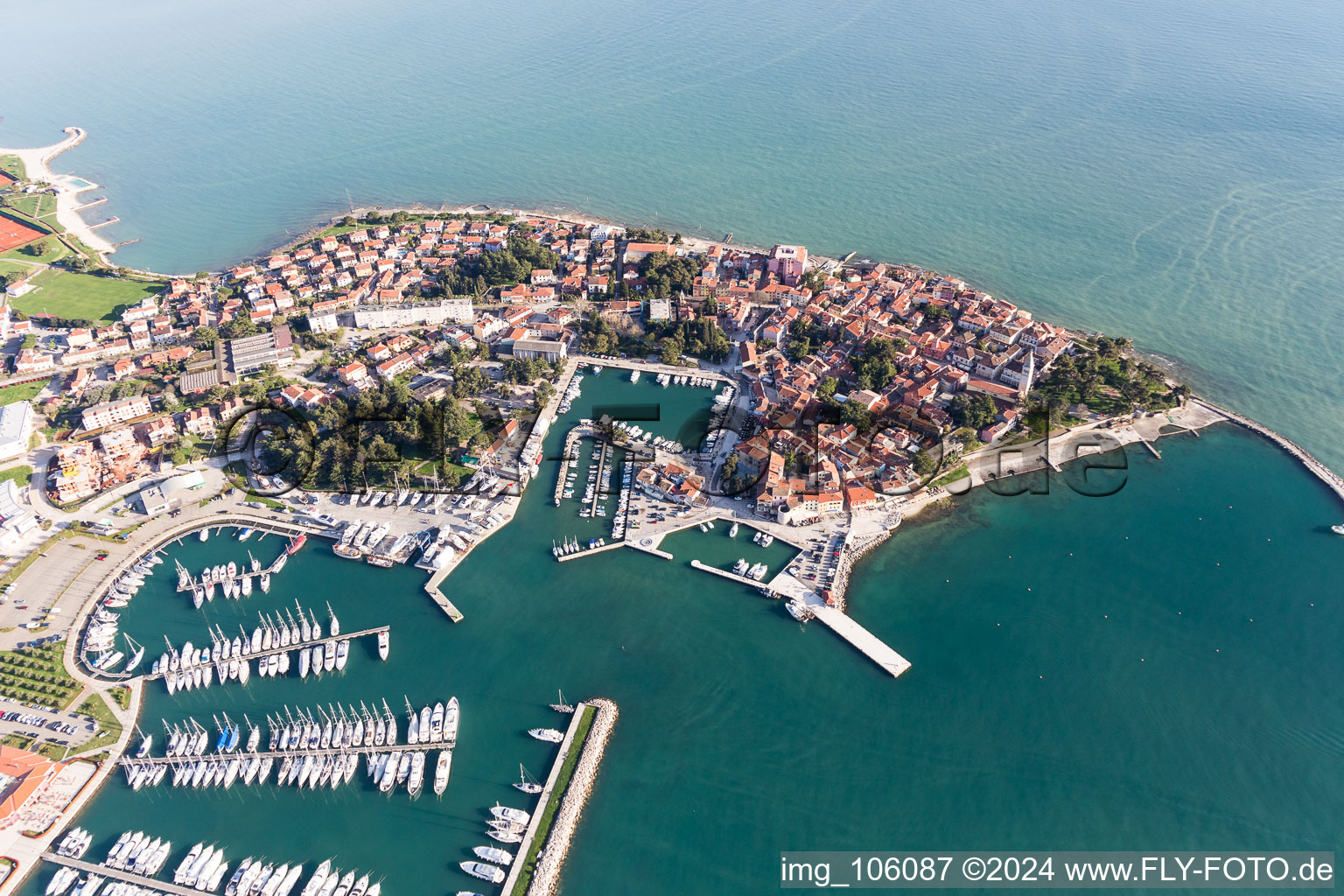 Aerial view of Pleasure boat marina with docks and moorings on the shore area of the Adriatic sea and old town of Novigrad in Istrien - Istarska zupanija, Croatia