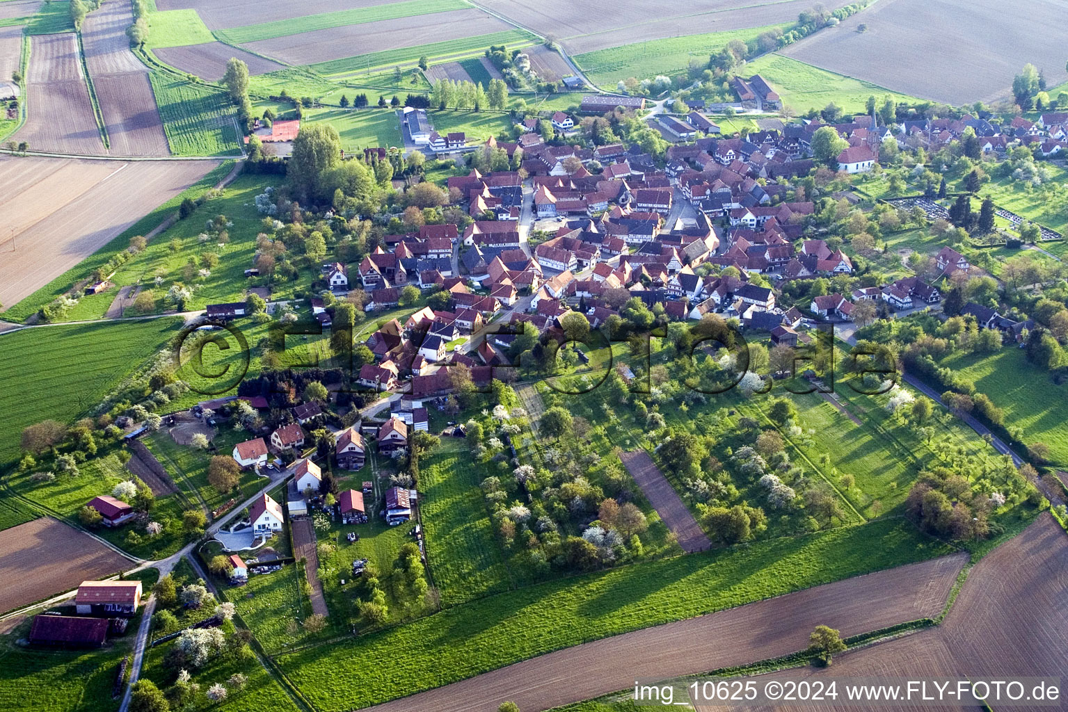 Village - view on the edge of agricultural fields and farmland in Hunspach in Grand Est, France