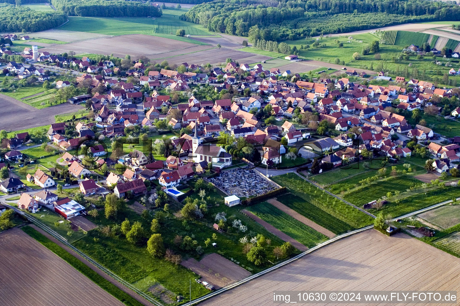 Oblique view of Village - view on the edge of agricultural fields and farmland in Schoenenbourg in Grand Est, France