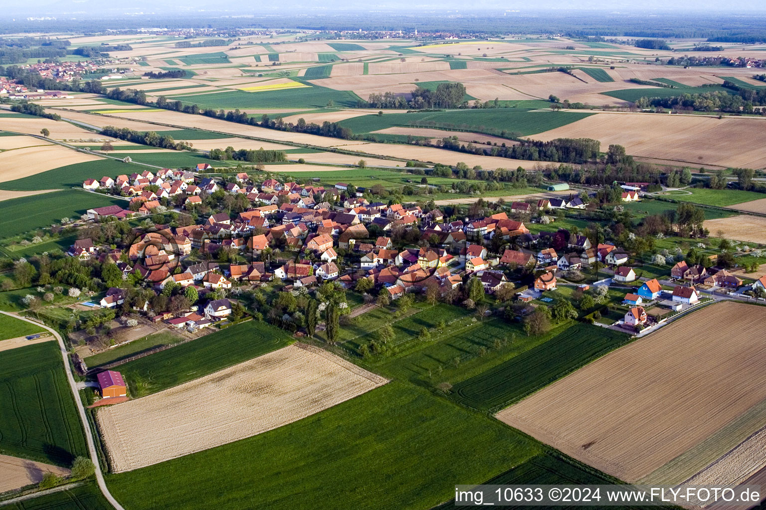 Aerial view of Village - view on the edge of agricultural fields and farmland in Hoffen in Grand Est, France